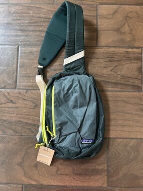 Patagonia Dark Green Sling Bag with Neon Yellow Zipper